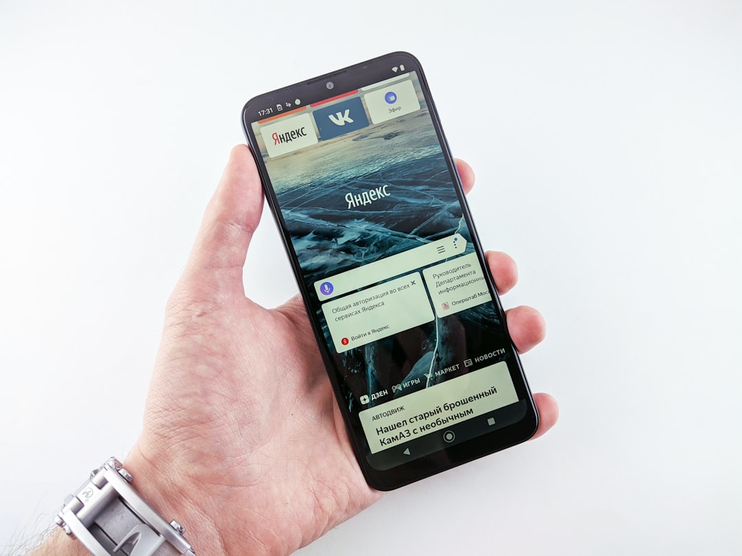 a person holding a smart phone in their hand