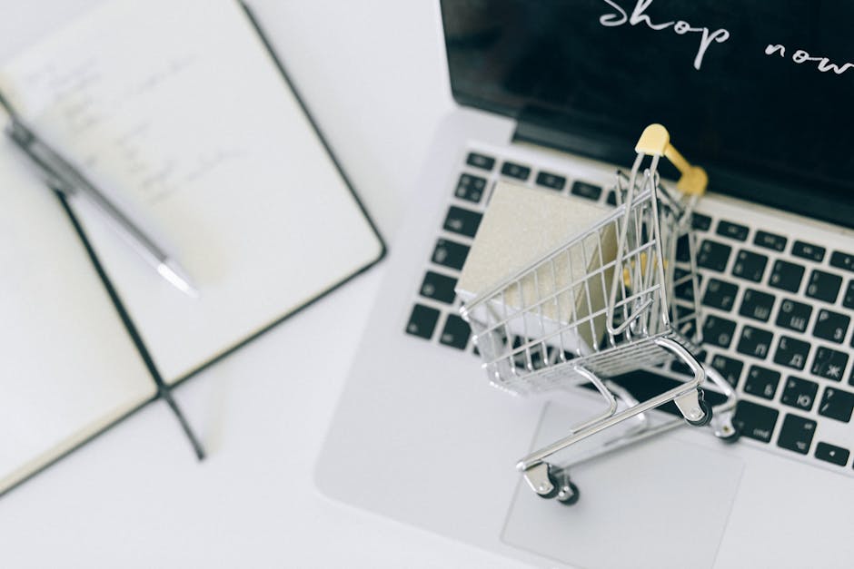 Miniature shopping cart on a laptop keyboard representing e-commerce deep linking
