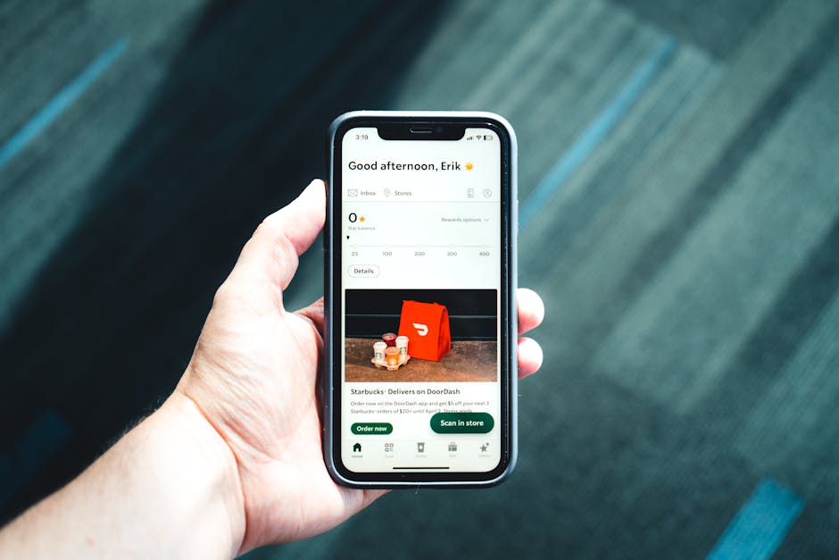 Person holding smartphone with food delivery app