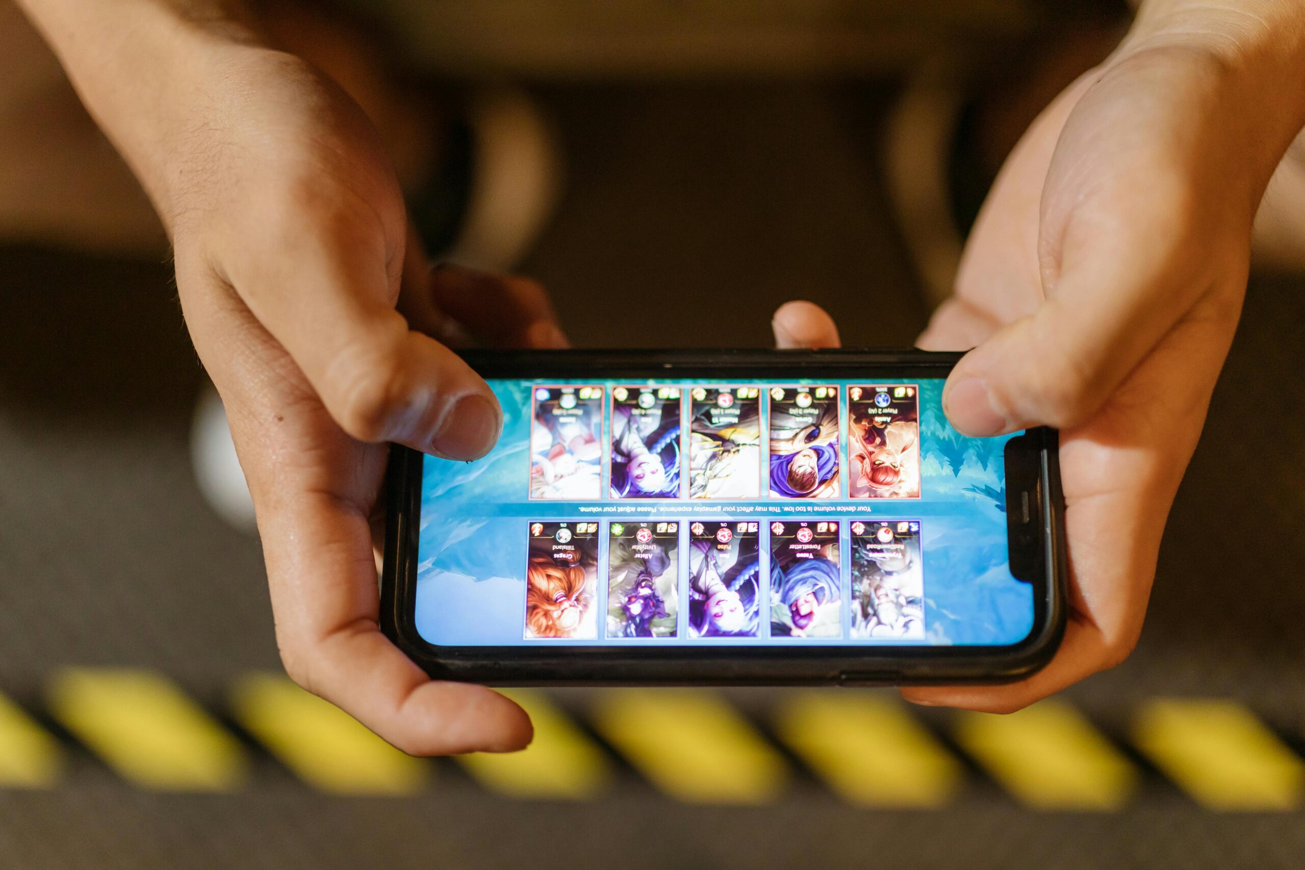 Hands playing mobile game on smartphone