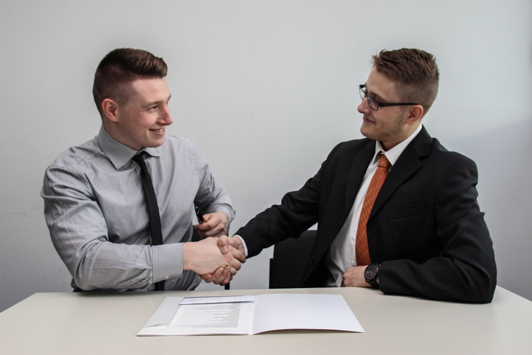 Two business professionals shaking hands in partnership
