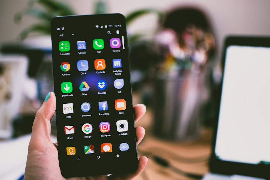 Hand holding a smartphone displaying various app icons, representing the first-time user experience