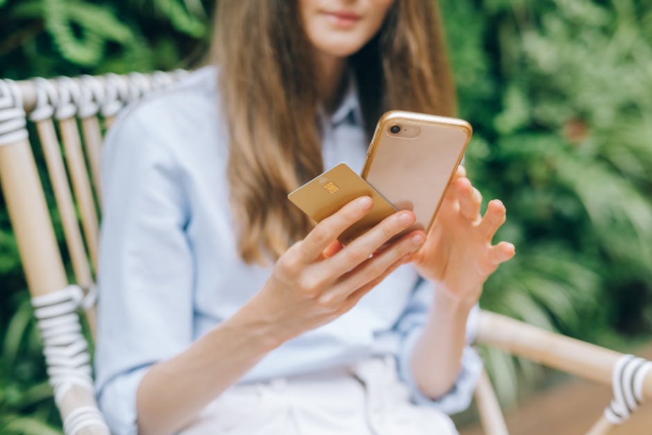 Person making a mobile payment with smartphone and credit card